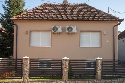 a house with two speakers on the side of it at Apartmani Bojana in Vrdnik