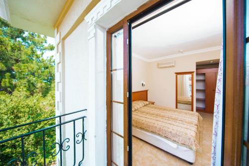 a bedroom with a bed on a balcony at Yel Holiday Resort in Oludeniz