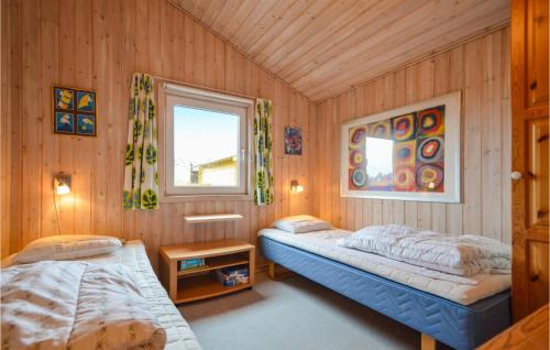 a bedroom with two beds and a window at Holiday Home Kap Farvel Rømø Ii in Bolilmark