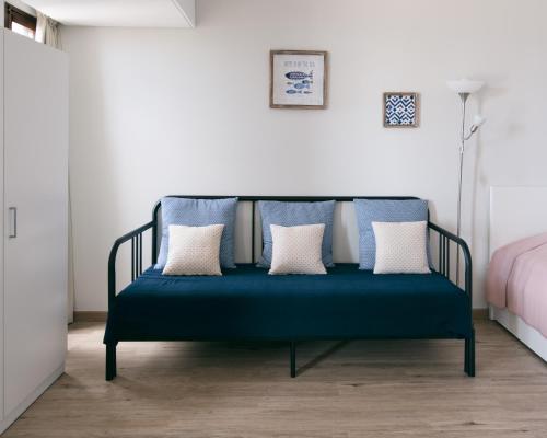 a blue bench with pillows in a bedroom at BINIS Apartment in Funchal