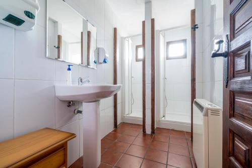 a bathroom with a sink and a mirror at Albergue Molino Solacuesta in Lerma