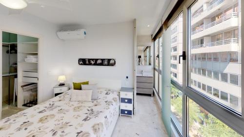 a bedroom with a bed and a large window at Marina Suite in Santa Cruz de Tenerife