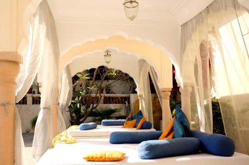 a group of beds in a room with an archway at Samode Haveli in Jaipur