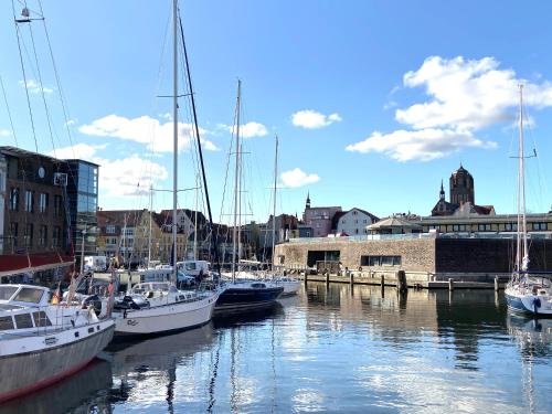 a group of boats are docked in a harbor at Hotel Kontorhaus Stralsund in Stralsund
