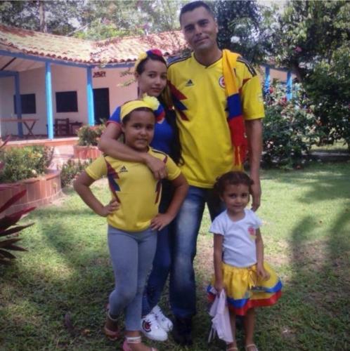 a man and two children are posing for a picture at Finca del Rio Palomino in Palomino