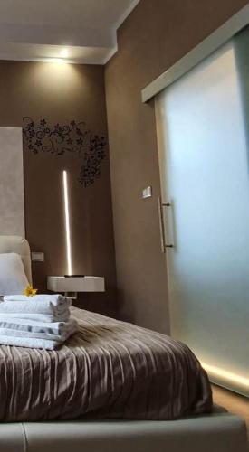 a room with a bed with a sliding glass door at casa ottaviano in Bologna