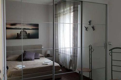 a bedroom with a bed and a glass wall at casa ottaviano in Bologna