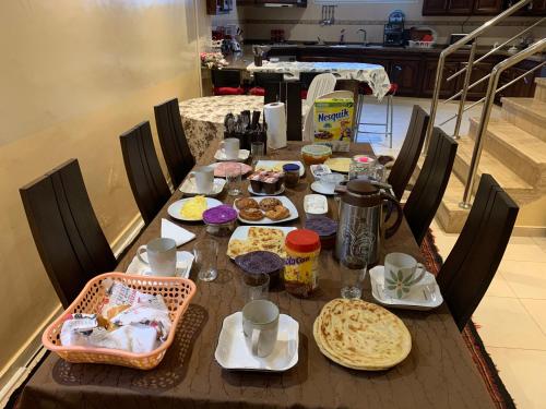 a wooden table with food on top of it at Au Cœur Des Plages de Rabat in Oulad Kerroum