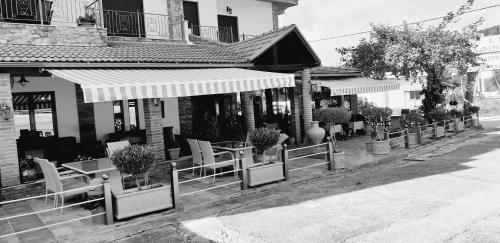 a black and white photo of a building with plants at Delfini Hotel in Menídion