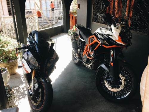 two motorcycles parked next to each other in a garage at Wogoxette Upstairs, A Private Kampung Stay In Cameron Highlands in Cameron Highlands