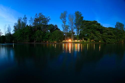 a large body of water at night with trees at Walindi Plantation Resort in Kimbe