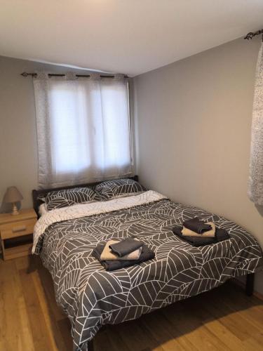 a bedroom with a bed with two towels on it at Aphrodite Hills Apartments-Stara Planina in Crni Vrh