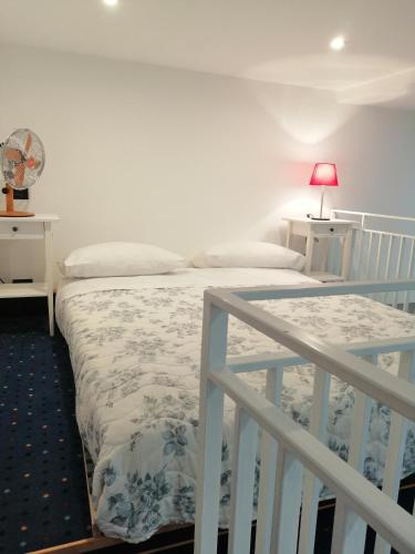 a bedroom with two beds and a white railing at CASA SACA' in Pompei