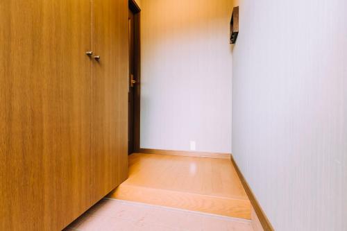 an empty hallway with a door and a wooden floor at LAKE TOYA Great view log cabin in Lake Toya