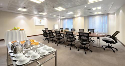 a conference room with a long table and chairs at Copthorne Hotel Sharjah in Sharjah