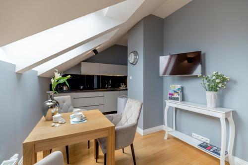 a kitchen and dining room with a table and chairs at Moon River Apartments Gdansk Old Town in Gdańsk