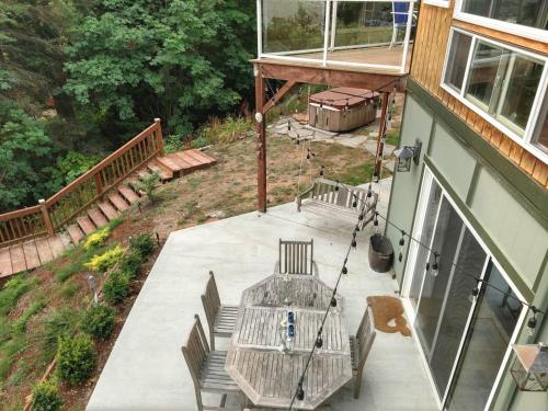 an overhead view of a porch with a table and swing at Sunrise Suite on the Sound in Anacortes