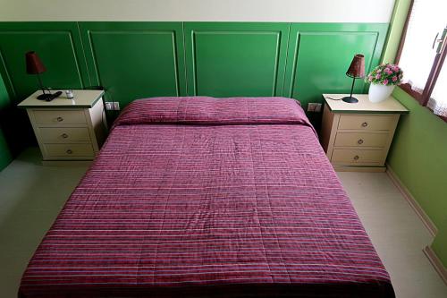a bedroom with a large bed with a red blanket at Albergo Ristorante La Rocca in Firenzuola