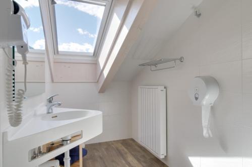 a bathroom with a sink and a window at Affittacamere La Ferrata in San Michele allʼAdige