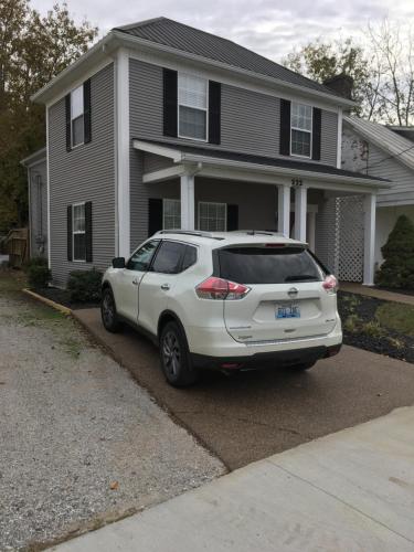 a white suv parked in front of a house at Downtown abode in the heart of the Bourbon Trail in Lebanon