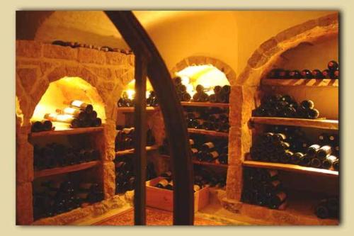 a room filled with lots of bottles of wine at De Zevende Hemel in Merendree