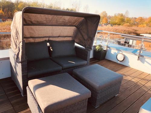 a couch sitting on the deck of a boat at Hausboot Elandi in Bitterfeld
