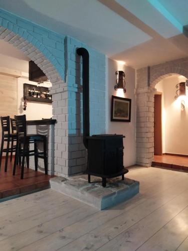 a living room with a brick fireplace and a table at Lux Apartment Sunset in Virpazar