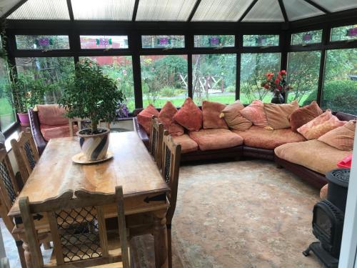 a living room with a couch and a table at Broadmoor Farm in Kilgetty