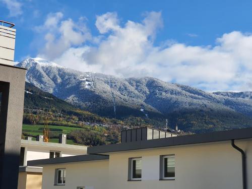 a building with a mountain in the background at Fewo Paul in Bressanone