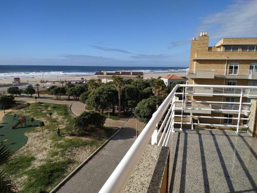 a balcony with a view of the beach and a building at Sun, Sky and Sea in Esmoriz