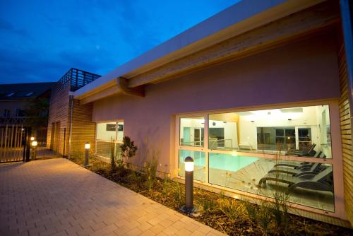 a house with a swimming pool in front of it at Résidence Les Rives de la Fecht - Colmar Ouest in Ingersheim