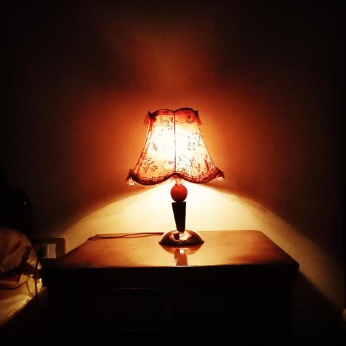 a lamp sitting on a table in a dark room at Safari Abu Simbel in Abu Simbel