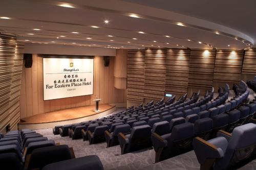 a conference room with chairs and a screen with a presentation at Shangri-La Far Eastern Tainan in Tainan