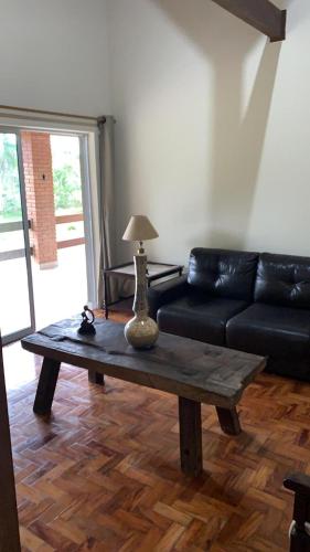 a living room with a couch and a coffee table at Refúgio das Araucárias in Ibiúna