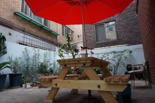 
a table with an umbrella on top of it at Duri Guest House in Seoul
