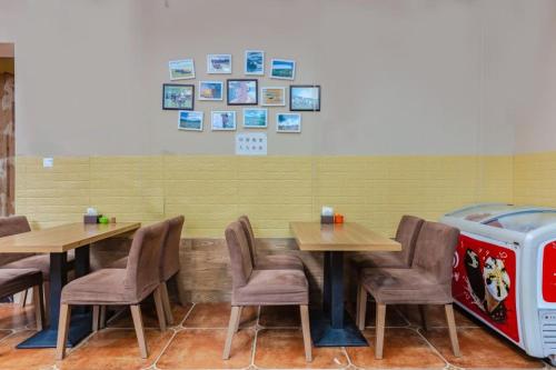 a dining room with two tables and a water cooler at Holly's Hostel in Chengdu