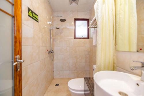 a bathroom with a sink and a toilet and a shower at Holly's Hostel in Chengdu