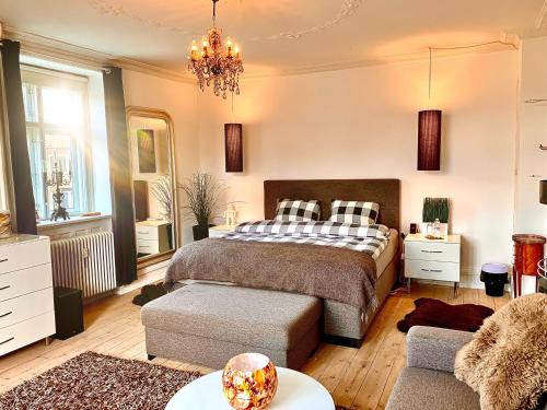 a bedroom with a bed and a couch at Four Individual Beautiful Spacious Rooms In Stylish Apartment in Copenhagen