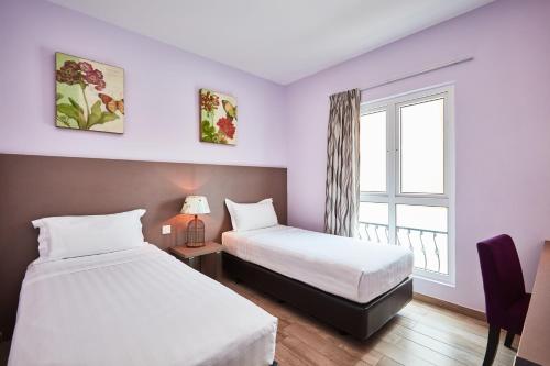 Ένα ή περισσότερα κρεβάτια σε δωμάτιο στο ibis budget Singapore Joo Chiat