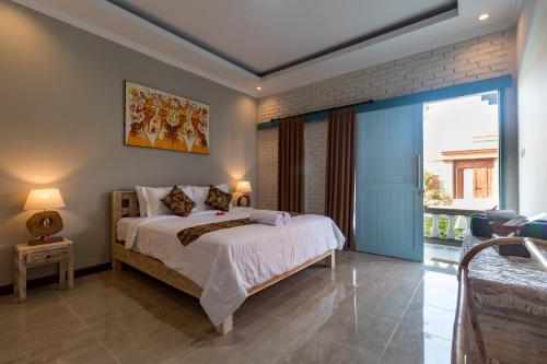 a bedroom with a bed and a large window at D-Anyar Stay and Surf Canggu in Canggu
