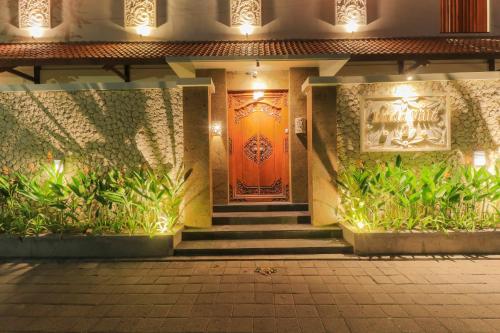 an entrance to a building with a orange door at Linda Villa 2 in Sanur