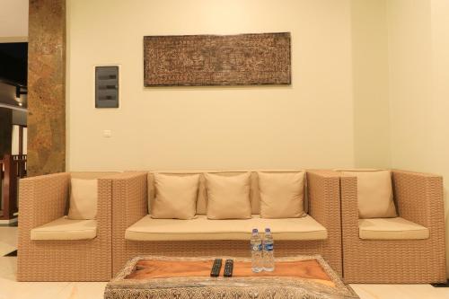 a living room with a couch and two water bottles at Linda Villa 2 in Sanur