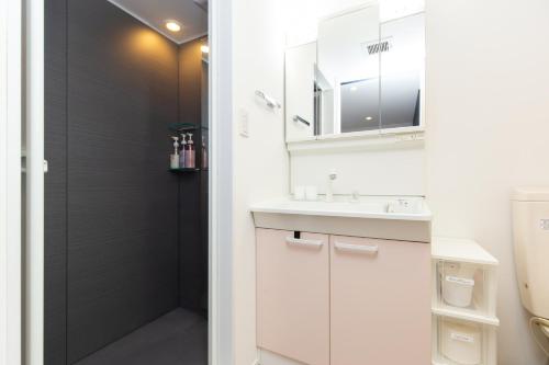 a bathroom with a sink and a shower at Cross Bridge Ikebukuro in Tokyo