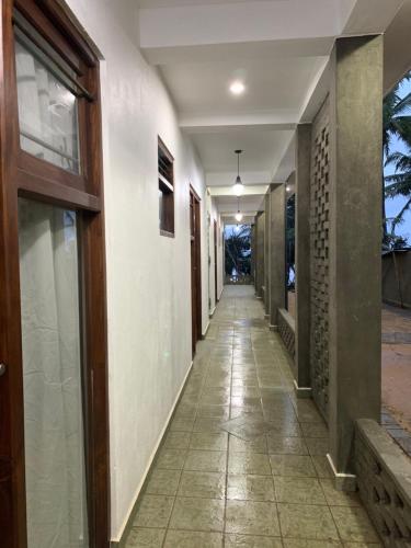 a corridor of a building with a hallway at Mirage Beach House at Morava Court in Hikkaduwa