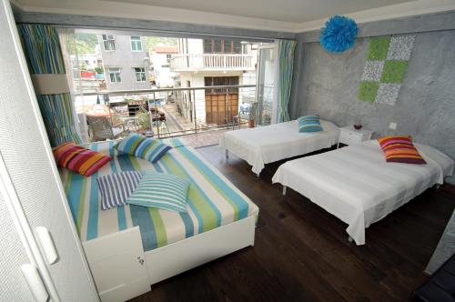 a bedroom with two beds and a balcony at Espace Elastique B&B with contactless check-in in Hong Kong