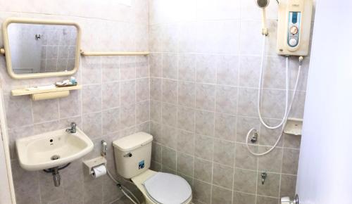 a bathroom with a toilet and a sink at Mali House in Mae Nam