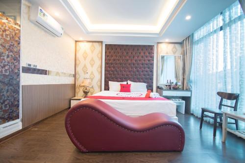 a bedroom with a large bed with a red headboard at The Royal Hotel Near West Lake in Hanoi