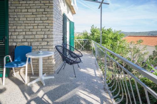 a patio with two chairs and a table on a balcony at Apartments PODATOK 4 in Primošten
