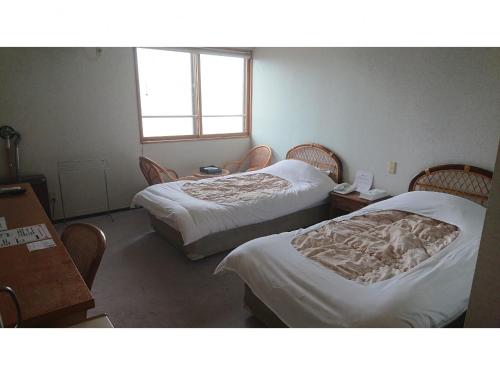 Un ou plusieurs lits dans un hébergement de l'établissement Daikokuya Ryokan