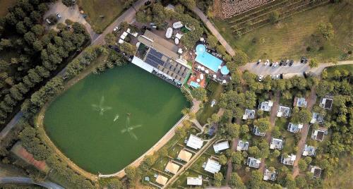 an overhead view of a lake with houses and trees at Villaggio La Pescaccia in San Clemente